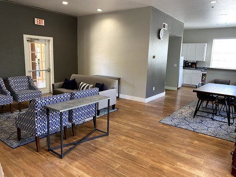 a living room and dining room with a table and chairs